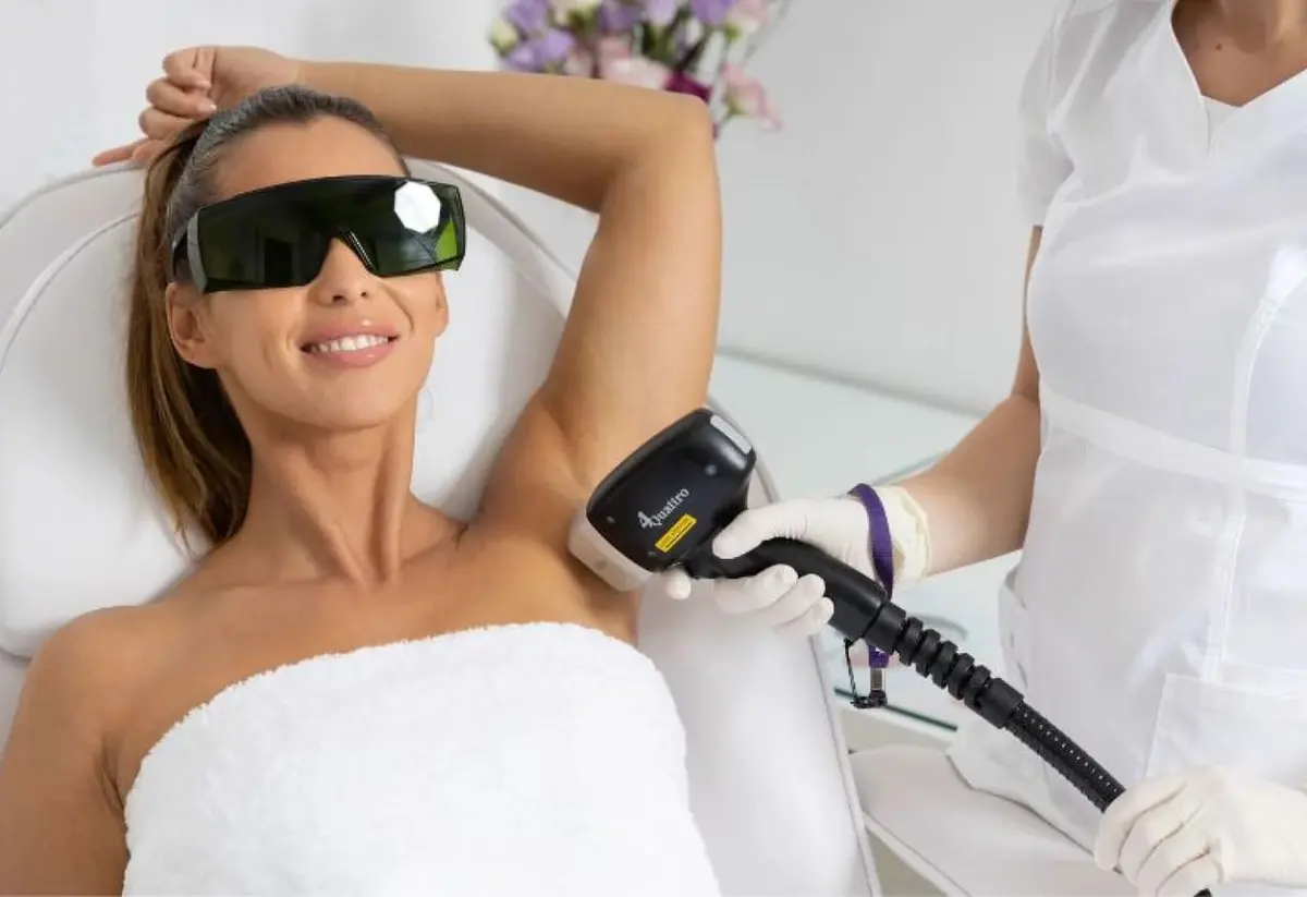 Woman wearing laser safety glasses having underarm laser hair removal