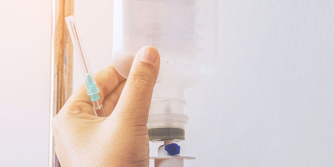 Smiling patient receiving NAD IV therapy at a nearby wellness clinic