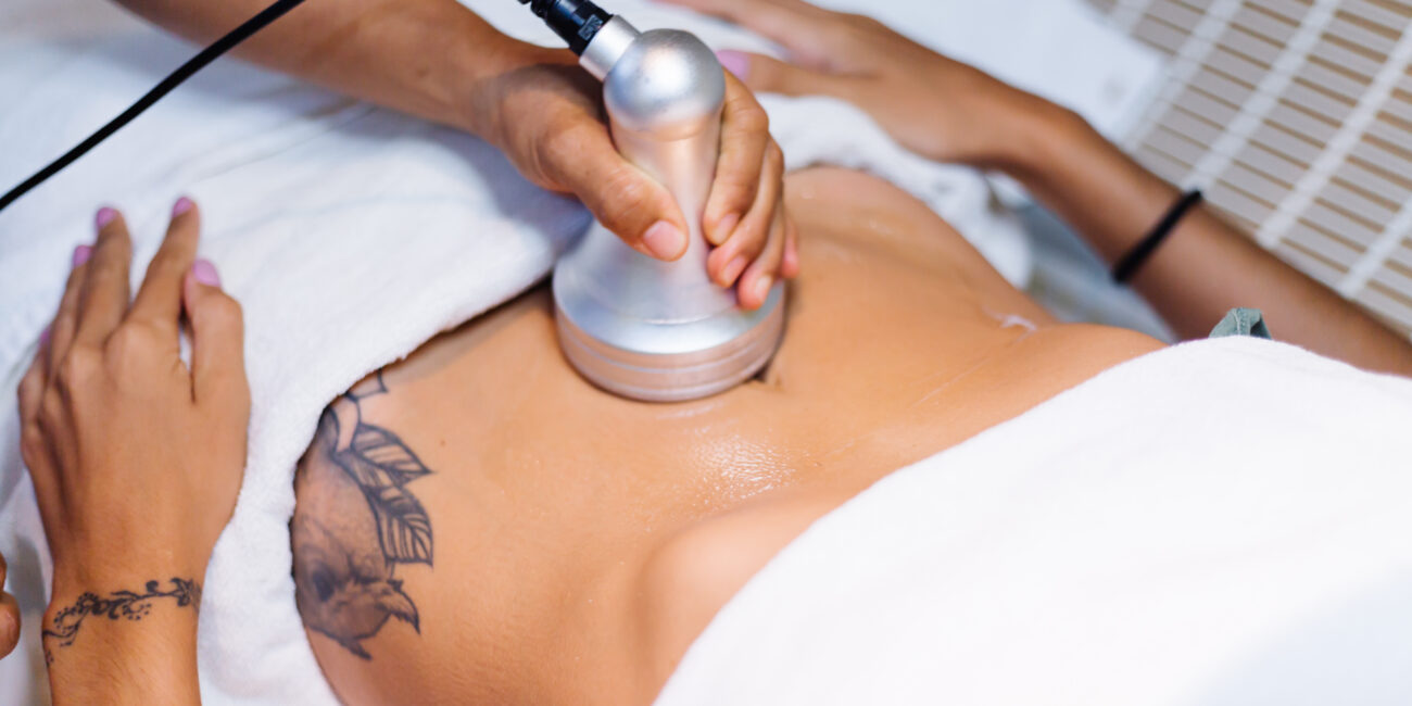 Ultrasound cavitation therapy being performed on abdomen area